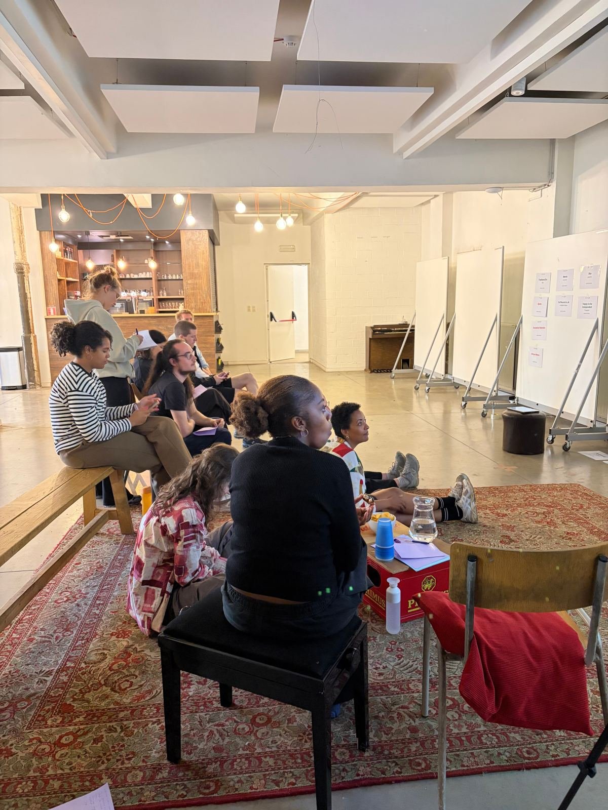 Participants seated around a studio during a Kimaté lab session